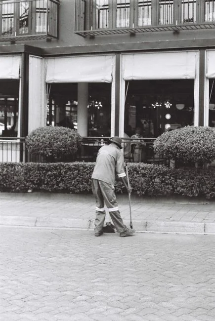 home-img A person in personal protective equipment vacuuming indoors, ensuring a thorough clean.